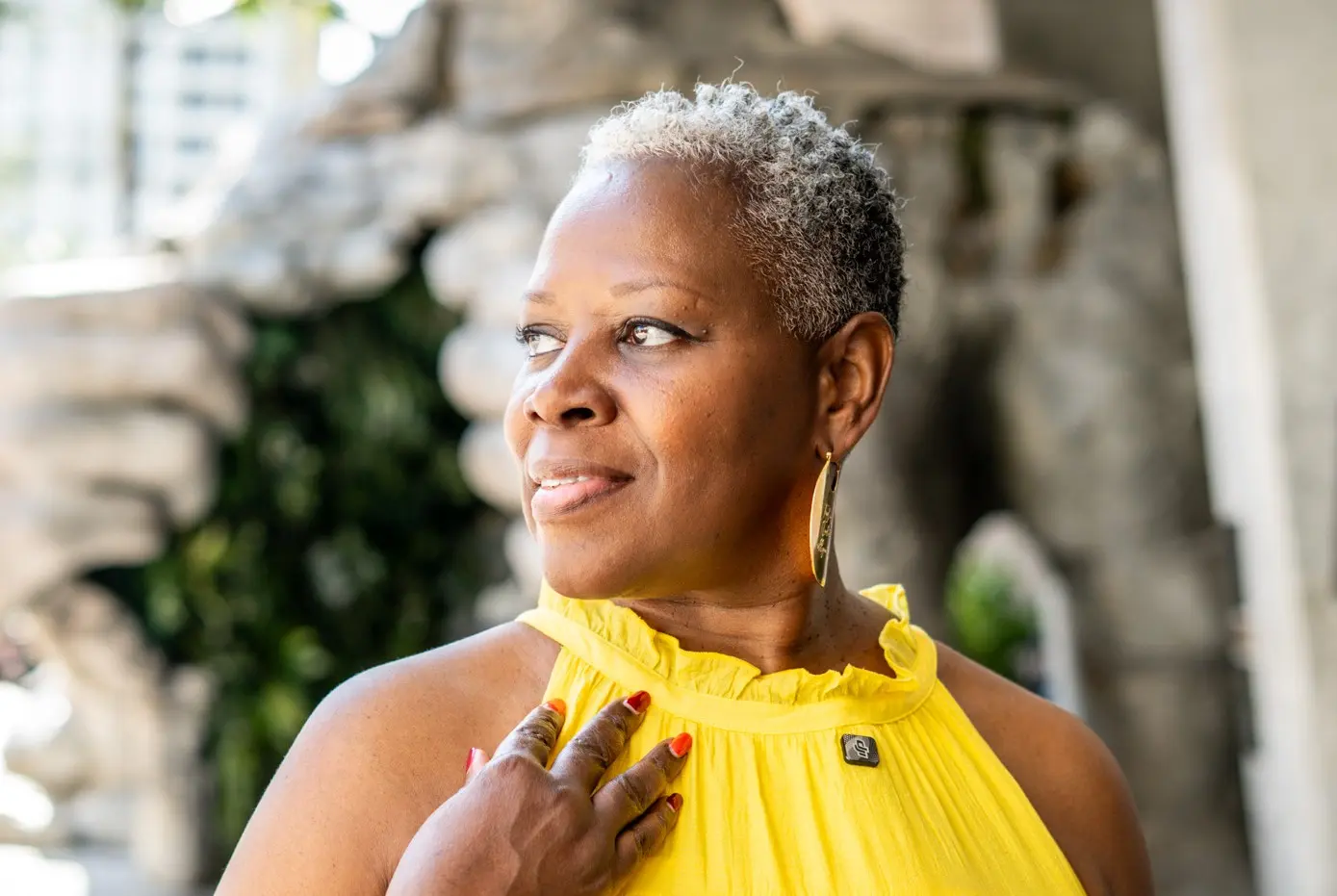 Linette Cottrell in a yellow blouse looking ahead